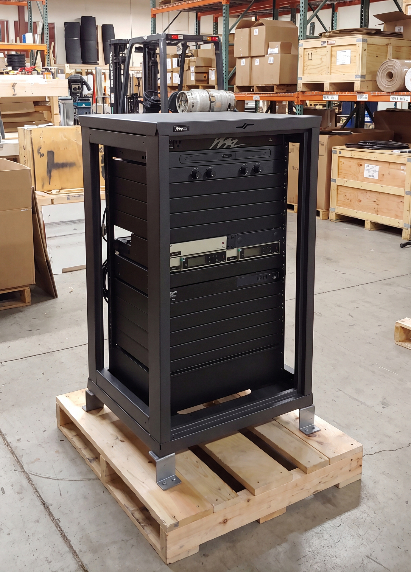 A configured equipment rack resting on a pallet in a warehouse