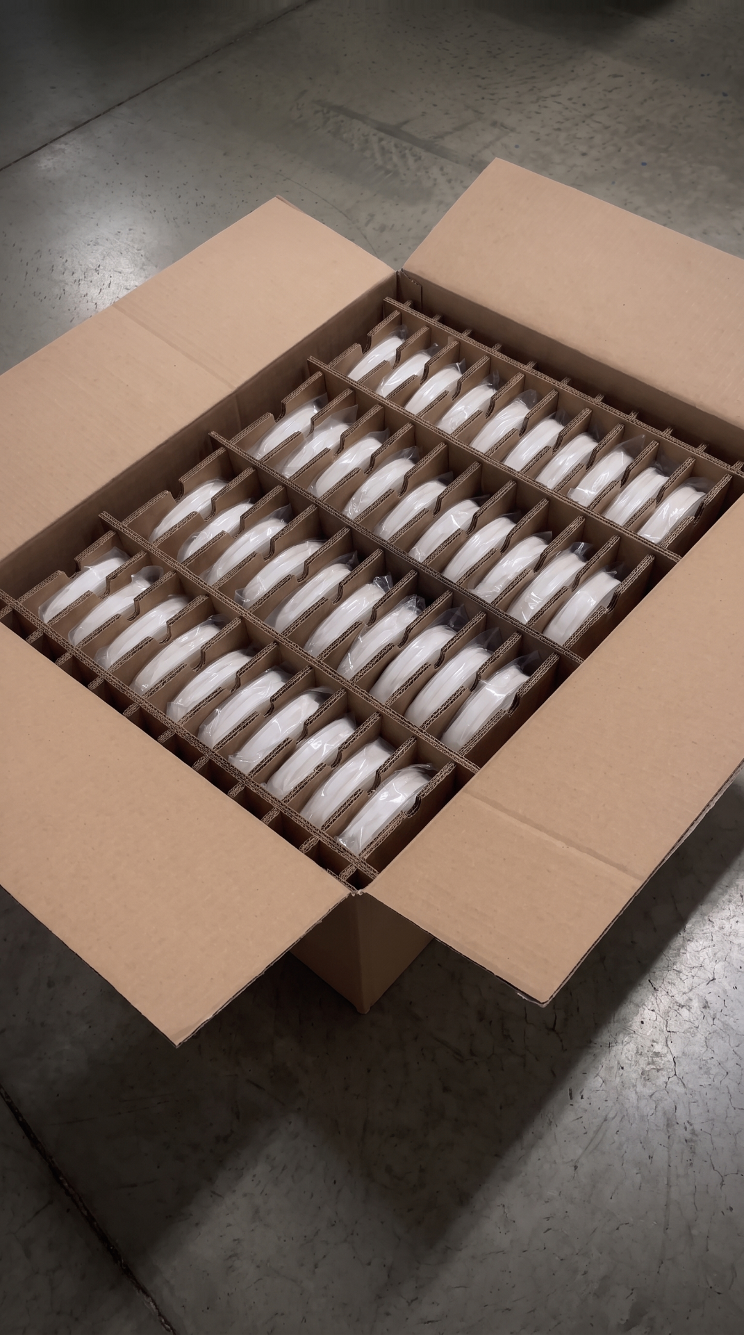 An open divided shipping box containing individually wrapped components