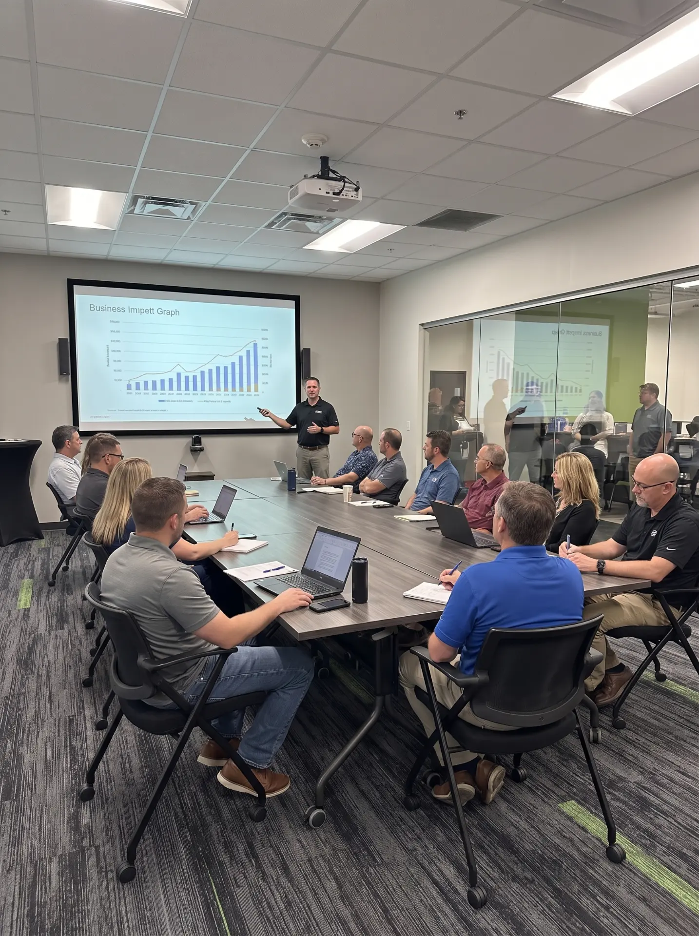 A sales team gathered in a conference room for a presentation