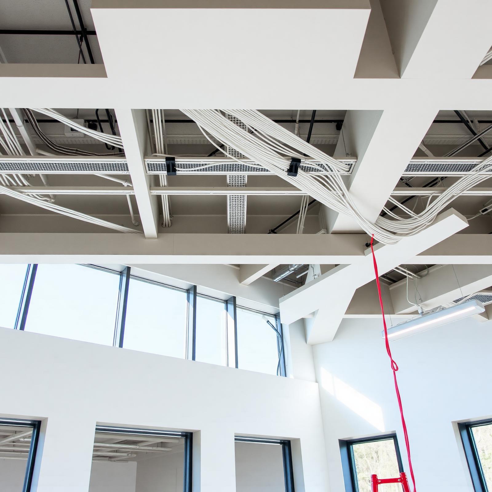 Exposed ducts, conduit, and cabling in an unfinished commercial interior